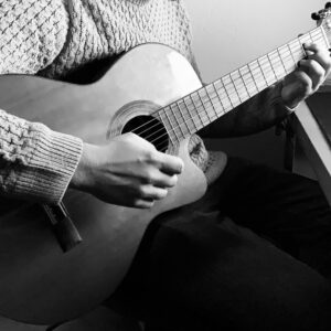 Handen die een klassieke gitaar bespelen